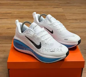 Nike Vomero Plus Sneakers in Black, White
