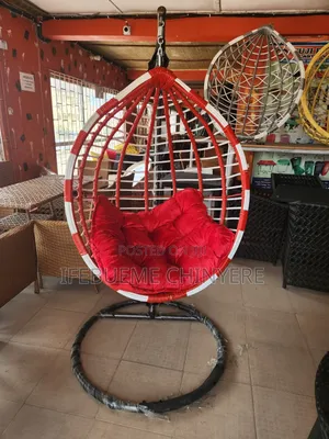 Red and White Swinging Chair With Red and Black Cushion