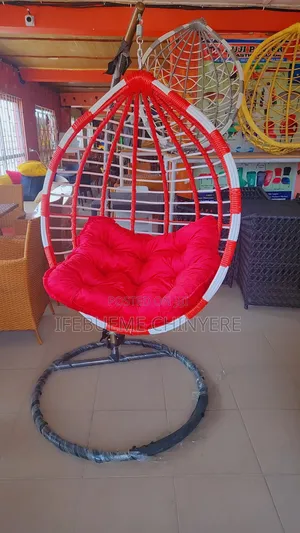 Red and White Swinging Chair With Red and Black Cushion