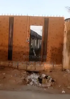 Half Plot of Land With Shops , Facing Road Construction in Ayobo