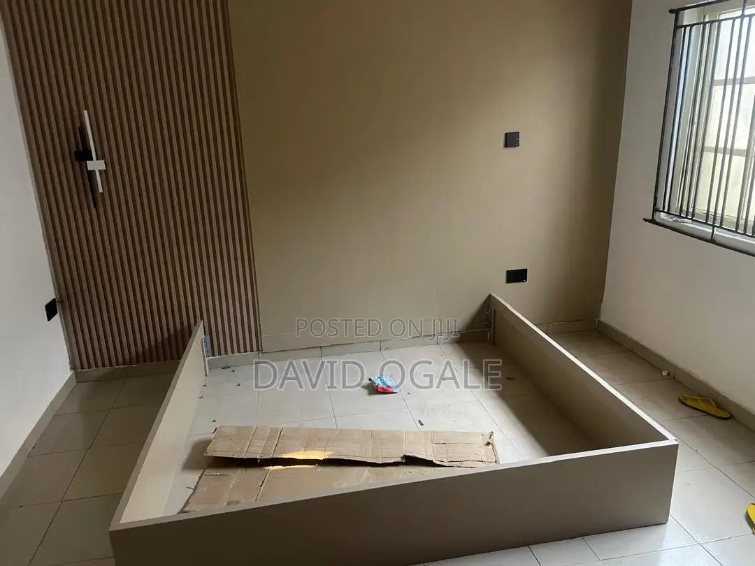 A Tan Colored Rectangular 6 by 6 Wooden Bed Frame