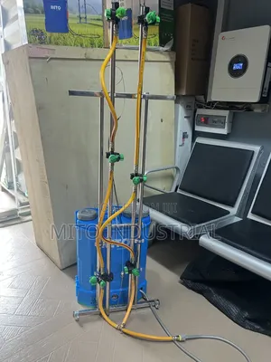 Battery Knapsack Sprayer With an Extended Vertical Boom Attachment.
