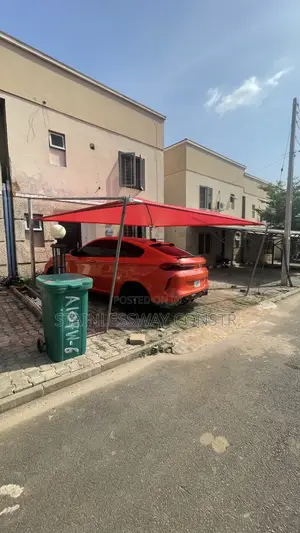 Carport With Galvanized Pipe and Red Cover: Tough, Bright