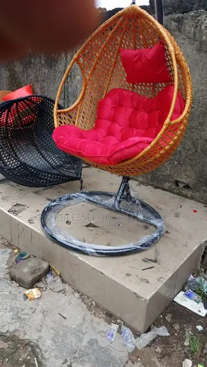Indoor and Outdoor Hanging Egg Chair Swing With a Red Cushion