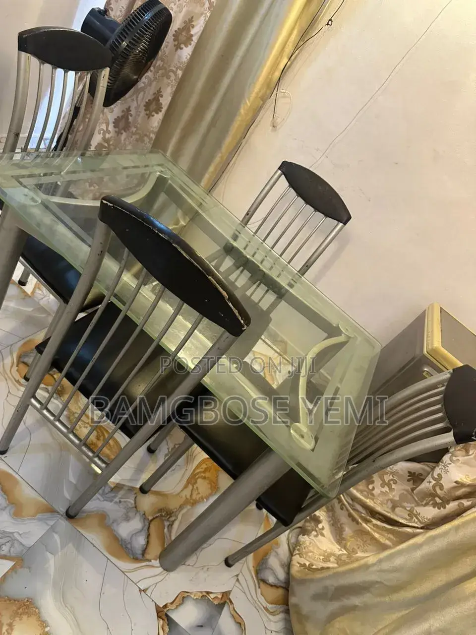 A Thick Glass Dinning Table With Four Chairs