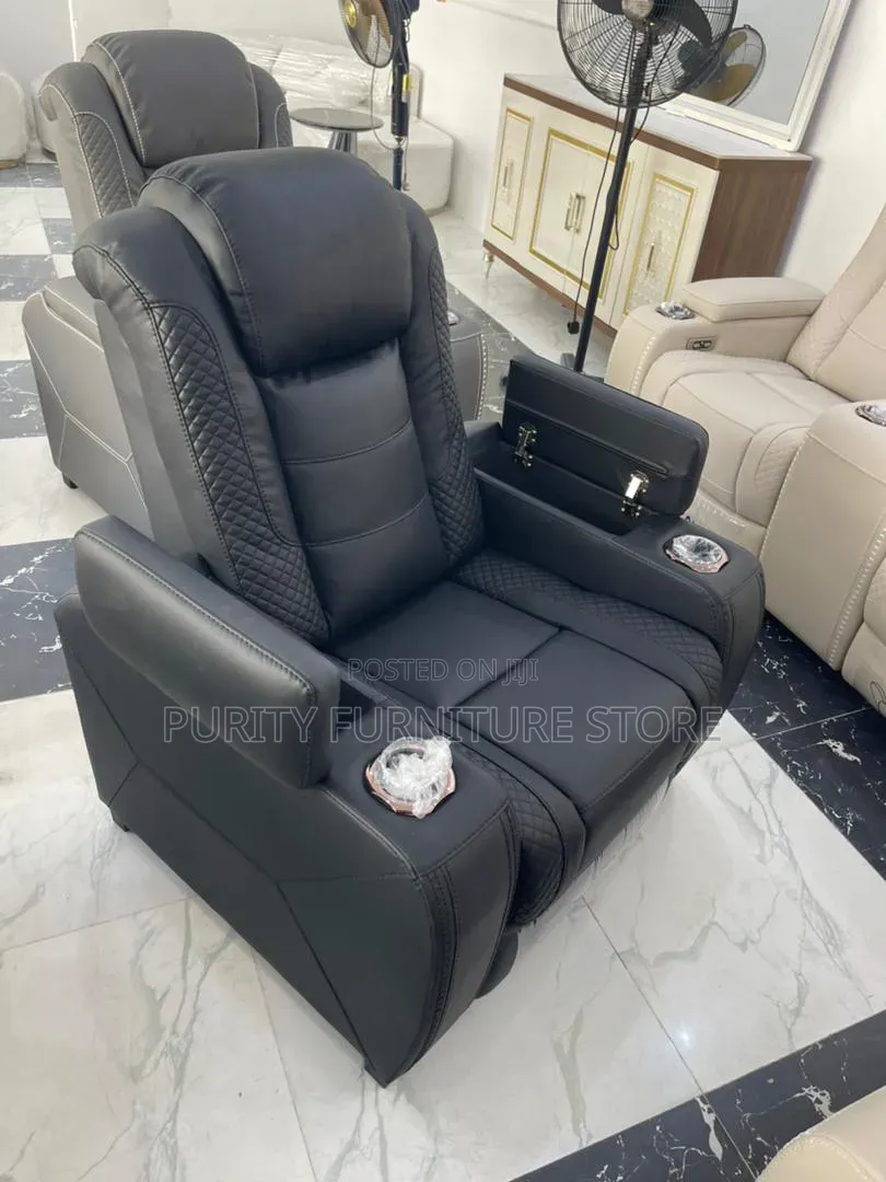 These Are White Leather Electric Recliner Sofas With a Center Console.