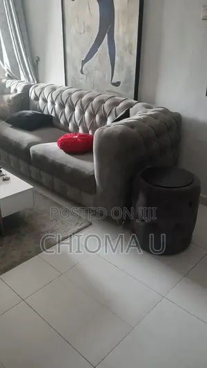 Neatly Used L Shape Chair With A Side Stool