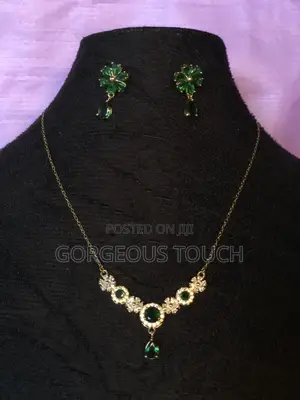 Elegant Gold-Tone Necklace Paired With Matching Drop Earrings
