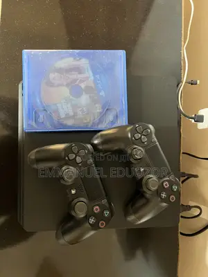 Clean Ps4 Console With Two Pads and Gta and Football Dics