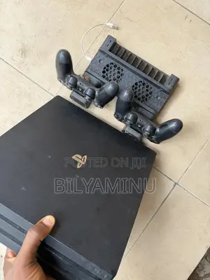 Sony Ps4 Pro With Two Pads and Standing Cooler