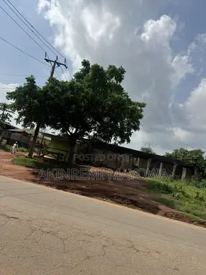 1 Acre of Land Fenceddirectly With 4 Shops