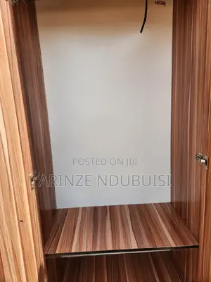 Wardrobe Features Three Doors and Two Lower Drawers