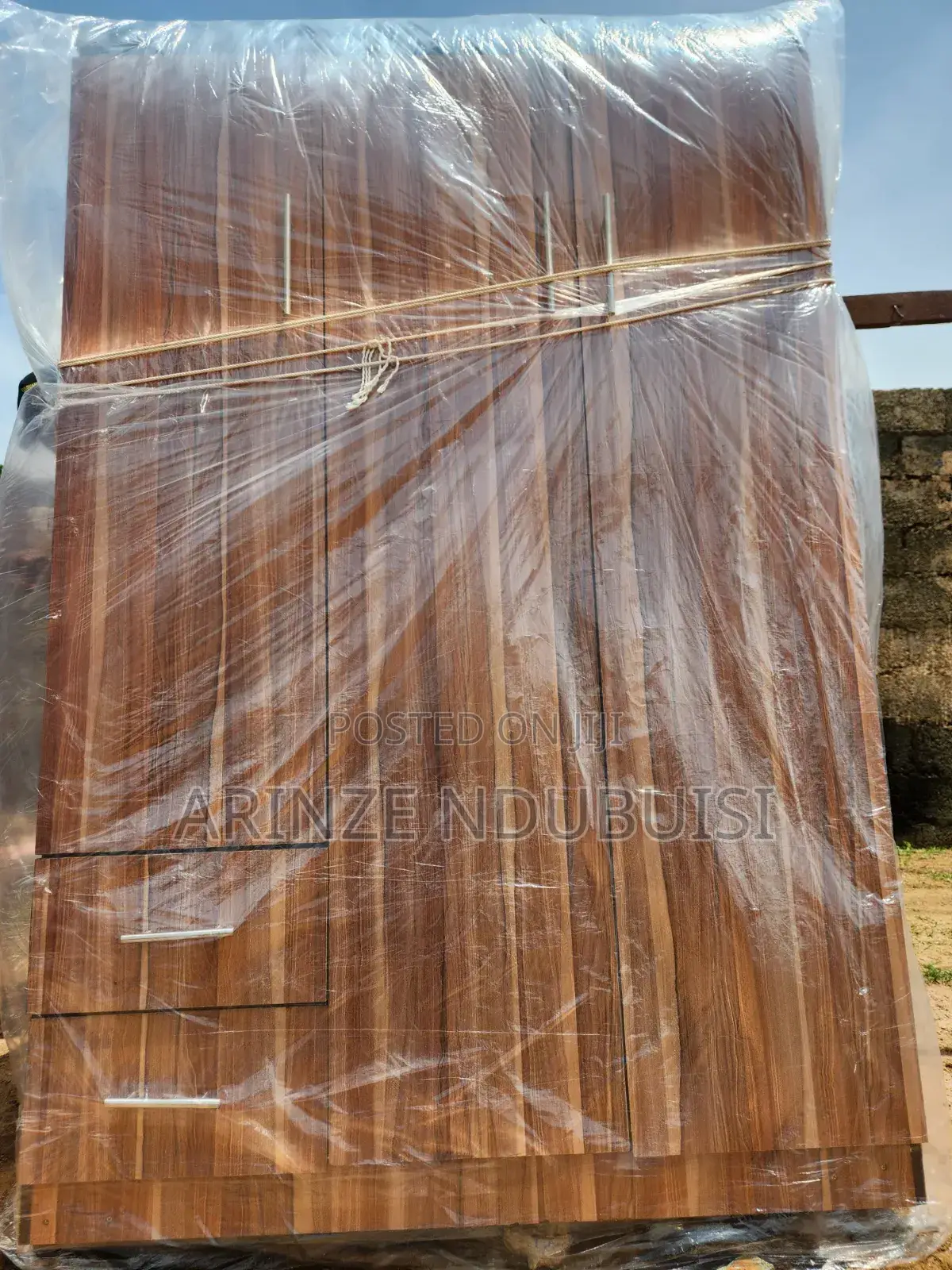 Wardrobe Features Three Doors and Two Lower Drawers