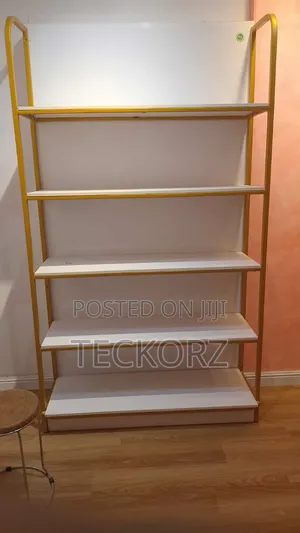 Golden Shelving Rack With White Backdrop