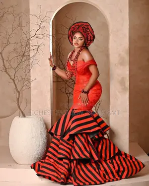 Elite Tiv-Inspired Red and Tiered Mermaid Bridal Gown With Gele