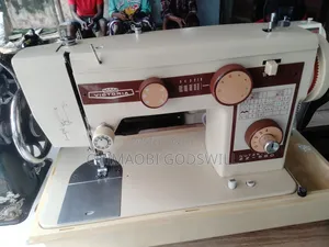 Original Electric and Manual Straight and Zigzag Sewing Machine.