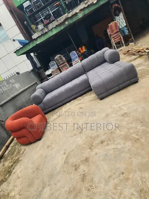 Grey L-Shaped Sofa Couch With Its Single Seater