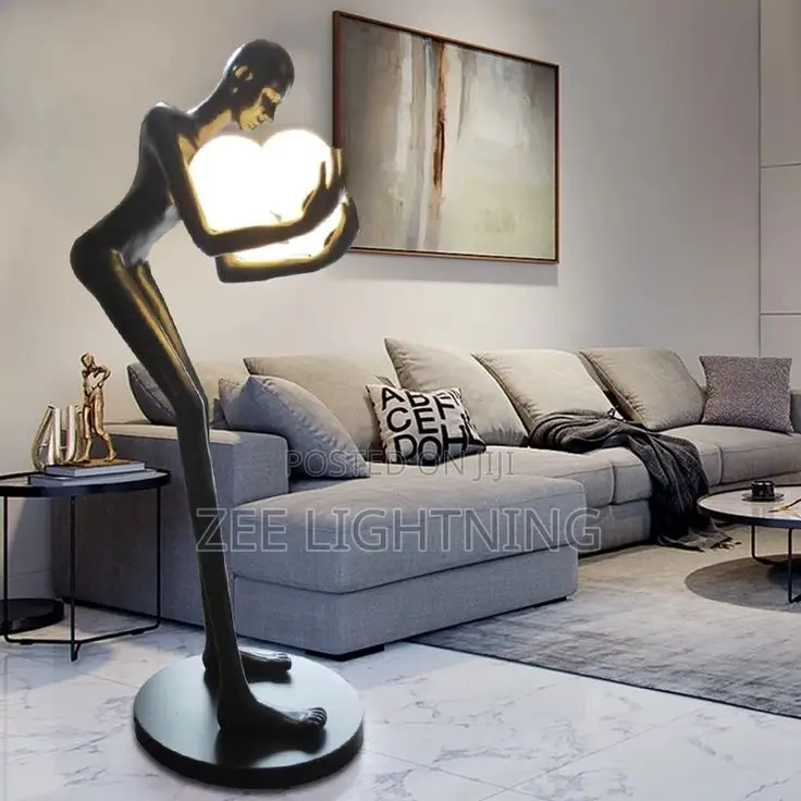 Humanoid Sculpture Carrying Silver and Blues Balls
