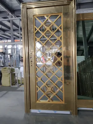 Golden Steel Glass Security Door With Intricate Geometric Patterns