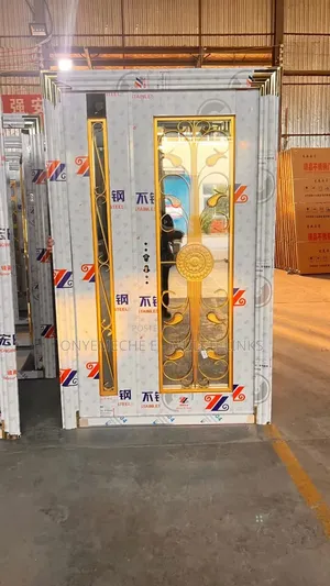 High-Security Stainless Steel Door With Golden Floral Design.
