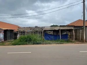 A Plot of Land With an Uncompleted Building Facing a Major Road