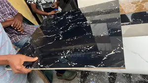 Black Polished Floor Tile Features White and Gold-Colored Veining