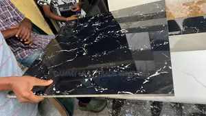 Black Polished Floor Tile Features White and Gold-Colored Veining
