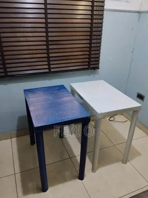 2 White and Blue Plastic Tables