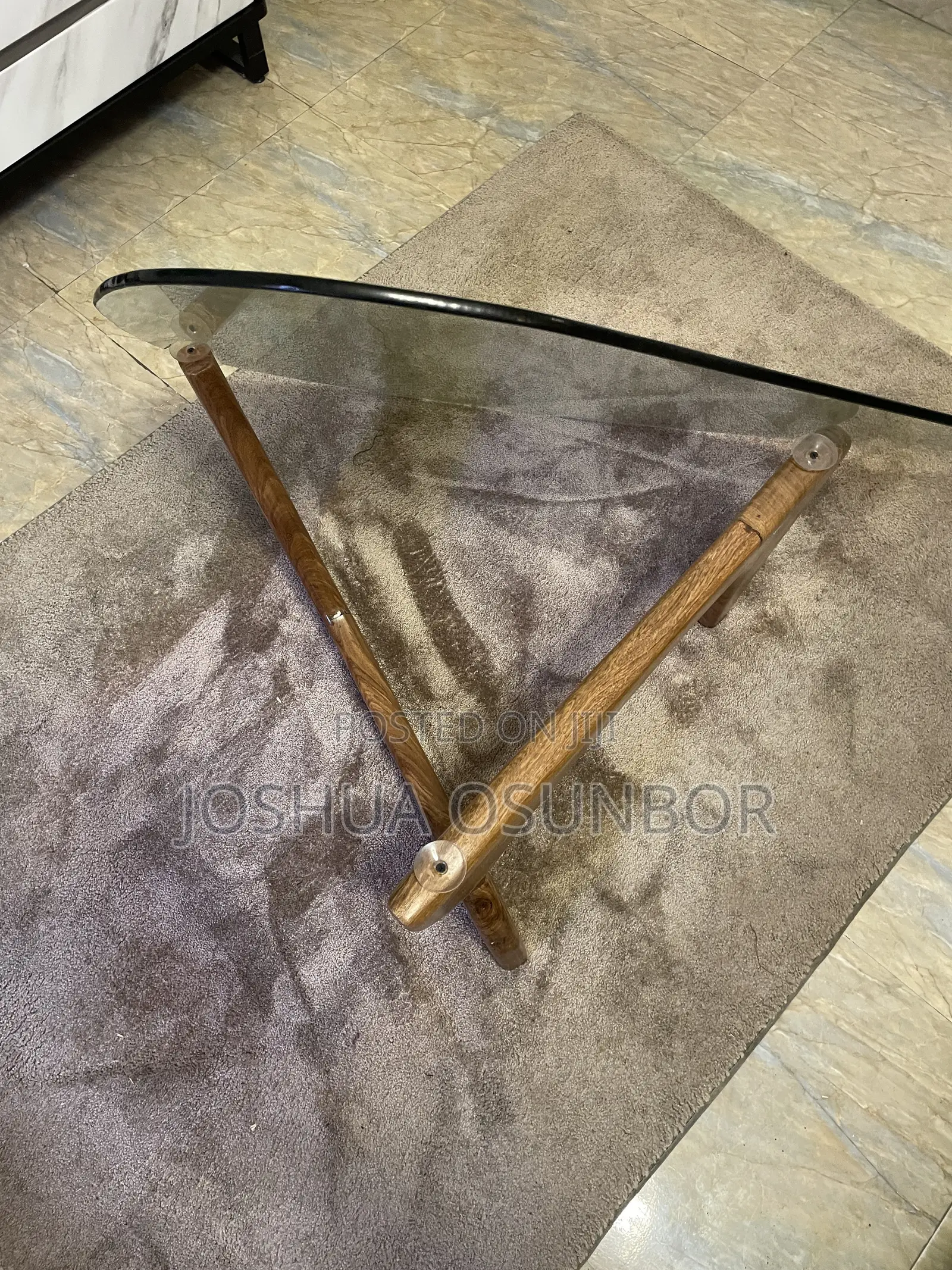 A Glass-Top Table on an Interlocking Two-Piece Wooden Base