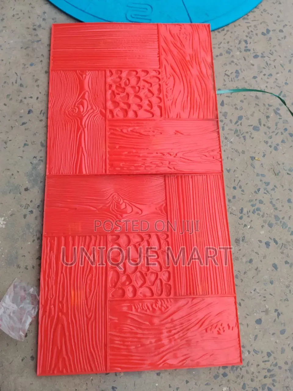 Red Concrete Stamp Mould Used to Create Textured Patterns on Pavement