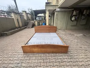Neatly Used Brown Wooden Bed Frame