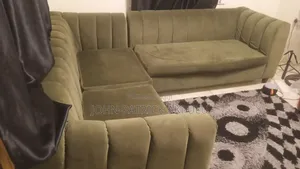 A Fairly Used Dark Green 5 Seater Couch