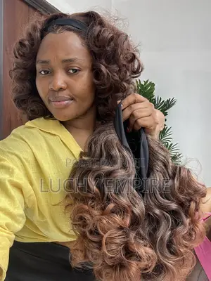 ₦35,000 Human Hair Blend Band Wig – Curly Brown Highlight