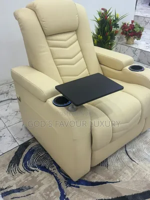 This Cream Leather Recliner Features a Built-in Tray Table .