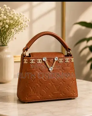 A Stylish Black Structured Handbag With Embossed Floral Patterns