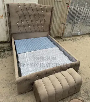 4.5 by 6 Upholstery Quality Bedframe With an Ottoman.