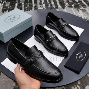 Prada Noir Regal Chain-Emblem Loafer.