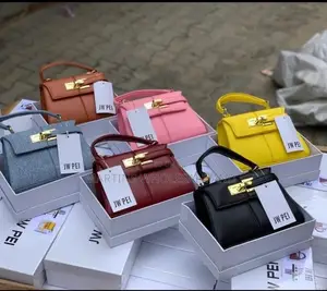 JW Pei Structured Top-Handle Handbags Feature a Distinctive Padlock-In
