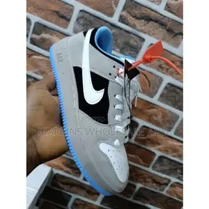 Grey, Black, and White Nike Low-Top Sneakers Feature a Prominent White