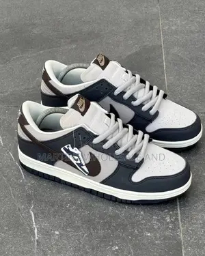 A Pair of Low-Top Nike SB Dunk Low "Otomo Katsuhiro" Sneakers Featurin