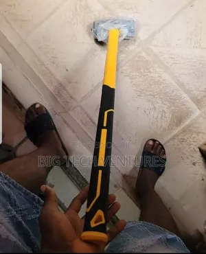 Shows a Heavy-Duty Sledgehammer With a Yellow and Black