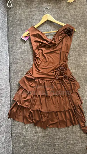 Rosette Cowl-Neck Tiered Mini Dress.” 