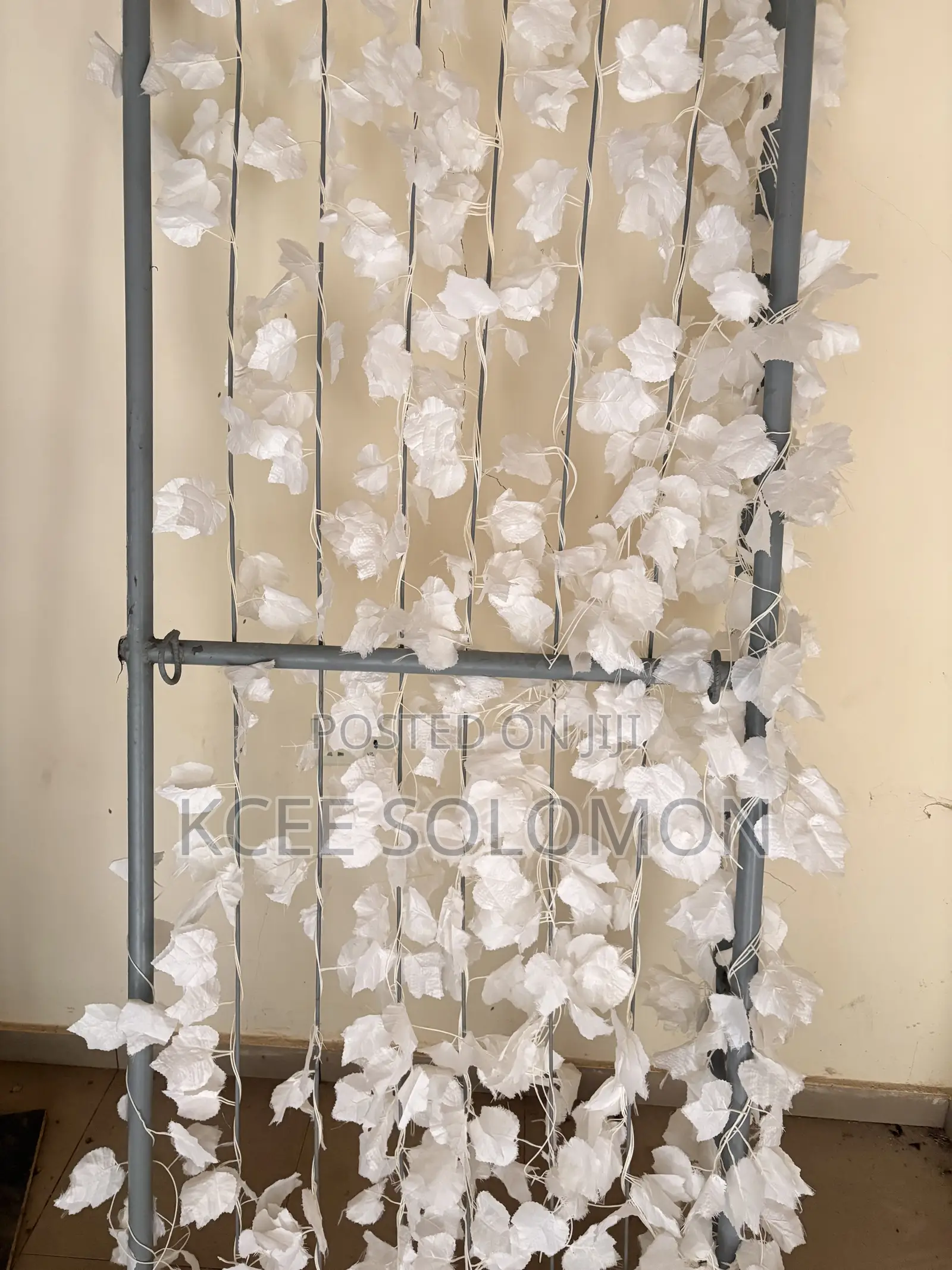 This Item Is a Metal Backdrop Stand With Hanging White Artificial Leaf