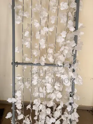This Item Is a Metal Backdrop Stand With Hanging White Artificial Leaf