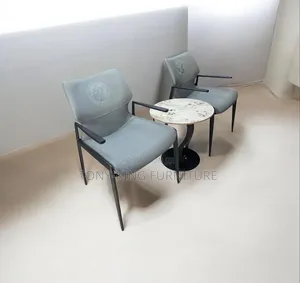 Modern Grey Armchair Features Sleek Dark Metal Framing