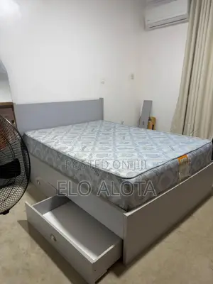 Bed and Bedframe With Storage by the Side.
