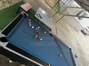 Pool Table With Balls and Cue Sticks
