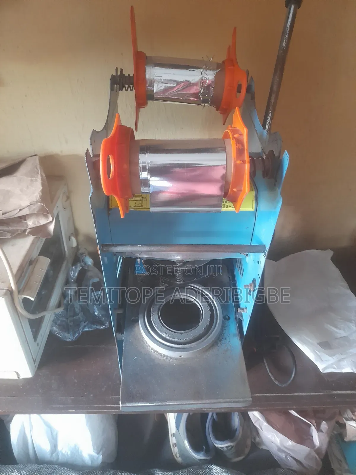 A Cup Sealing Machine.