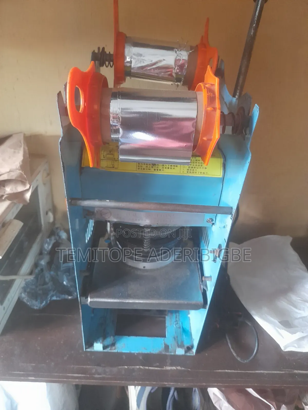 A Cup Sealing Machine.