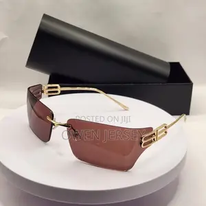 Balenciaga Rimless Shield Sunglasses – Gold-Tone With Brown Lenses.